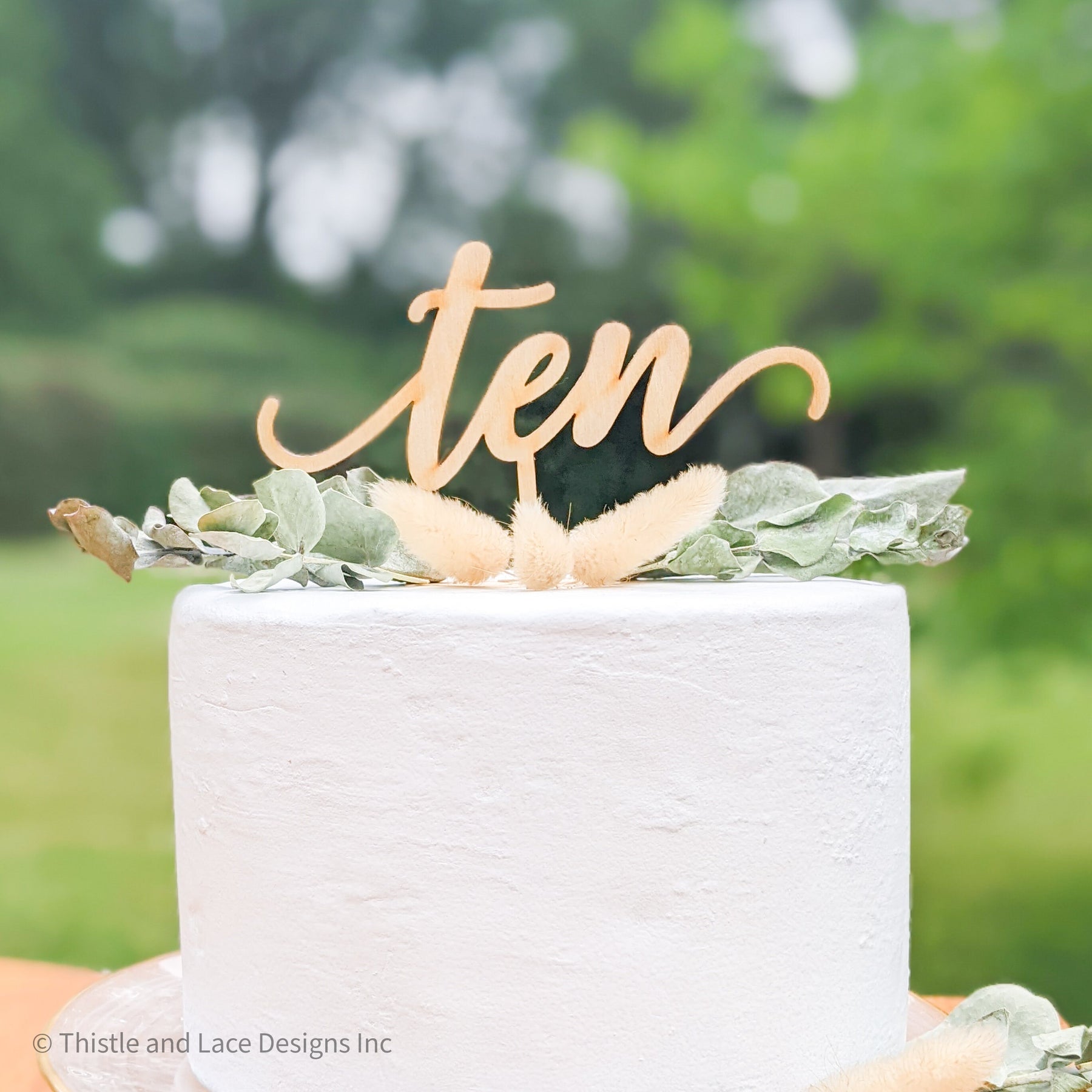 Stylish rustic wedding cake with lavender and thistle decor on vintage  stand on table at wedding reception in restaurant. Modern beautiful  provence we Stock Photo - Alamy